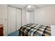 A bright bedroom has a bed and closet doors offering storage solutions and a tidy living space at 4801 Blanco Dr, Zephyrhills, FL 33541