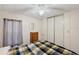 Bright bedroom with closet and dresser providing essential storage, complemented by a ceiling fan for comfort at 4801 Blanco Dr, Zephyrhills, FL 33541