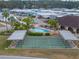 Aerial image shows shuffleboard courts and a community pool surrounded by lush greenery and mature palm trees at 4801 Blanco Dr, Zephyrhills, FL 33541