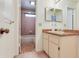 Bathroom featuring a tub and shower, a window, and a vanity with a sink at 4802 W Dryad St, Tampa, FL 33629