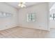 Spacious bedroom featuring neutral carpet, a ceiling fan, and bright windows at 4802 W Dryad St, Tampa, FL 33629