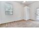 Bright bedroom with plush carpet, closet and a glass door leading to the outside at 4802 W Dryad St, Tampa, FL 33629