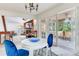 Breakfast nook with table, blue chairs, and view into the living room and access to the deck at 4802 W Dryad St, Tampa, FL 33629