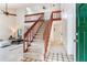 Inviting foyer showcasing staircase with wood railing, tile flooring, and access to the living room at 4802 W Dryad St, Tampa, FL 33629