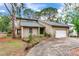 Charming home featuring a well-maintained lawn, lush landscaping, and a welcoming front entrance at 4802 W Dryad St, Tampa, FL 33629