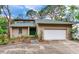Charming home with attached garage and well-maintained lawn, lush landscaping, and a welcoming front entrance at 4802 W Dryad St, Tampa, FL 33629