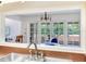 Kitchen pass-through provides view to French doors accessing outdoor living space at 4802 W Dryad St, Tampa, FL 33629