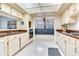 Bright eat-in kitchen with white cabinets, tiled floor and a cozy bench at 4802 W Dryad St, Tampa, FL 33629