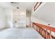 Bright living room with built-in shelves and wooden railing overlooking the lower level at 4802 W Dryad St, Tampa, FL 33629