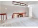 View of the upstairs living room with a wooden railing and a clerestory window at 4802 W Dryad St, Tampa, FL 33629