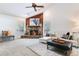 Open living room featuring stone fireplace, wood paneling, vaulted ceiling and comfortable seating at 4802 W Dryad St, Tampa, FL 33629