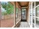 Covered outdoor deck with a ceiling fan and screened entry at 4802 W Dryad St, Tampa, FL 33629