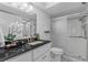 Well-lit bathroom features a granite-topped vanity and glass-enclosed shower at 4900 Brittany S Dr # 808, St Petersburg, FL 33715