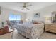 Bright bedroom features a starfish-themed bed, balcony access, and serene decor for a relaxing retreat at 4900 Brittany S Dr # 808, St Petersburg, FL 33715