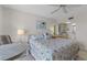 Bright bedroom with a comfortable bed and views to the ensuite bath and balcony at 4900 Brittany S Dr # 808, St Petersburg, FL 33715