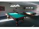 Recreational billiards room featuring two well-maintained pool tables and ample lighting at 4900 Brittany S Dr # 808, St Petersburg, FL 33715
