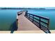 Long wooden dock on a sunny day with a bench, railing, and view of the water at 4900 Brittany S Dr # 808, St Petersburg, FL 33715
