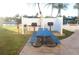 Outdoor grilling area with stainless steel grills, picnic table, and adjacent canal views at 4900 Brittany S Dr # 808, St Petersburg, FL 33715