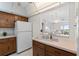 Kitchen with light countertops and pass-through to the living area at 4900 Brittany S Dr # 808, St Petersburg, FL 33715