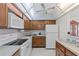 Efficient kitchen with white appliances and ample cabinet space at 4900 Brittany S Dr # 808, St Petersburg, FL 33715