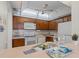 Cozy kitchen featuring white appliances and updated backsplash at 4900 Brittany S Dr # 808, St Petersburg, FL 33715