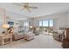 Bright living room with tile floors, comfortable seating, and sliding glass doors to a balcony with scenic views at 4900 Brittany S Dr # 808, St Petersburg, FL 33715