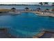 Beautiful pool and bay view, featuring lounge chairs and thatched umbrellas with easy access to the water at 4900 Brittany S Dr # 808, St Petersburg, FL 33715
