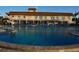 Large, inviting pool with clear water and depth markings, surrounded by lounge chairs and tropical landscaping at 4900 Brittany S Dr # 808, St Petersburg, FL 33715