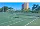 Tennis court with nets in front of a high-rise condo in the background at 4900 Brittany S Dr # 808, St Petersburg, FL 33715