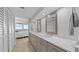 Bright bathroom featuring double vanity with white marble countertops and framed mirrors with access to ensuite bedroom at 500 Treasure Island Cswy # 704, Treasure Island, FL 33706