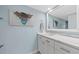 Bathroom with updated vanity, quartz countertops, and decorative mirror at 500 Treasure Island Cswy # 704, Treasure Island, FL 33706