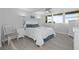 Light and airy bedroom features wood-look flooring and a plush king-sized bed at 500 Treasure Island Cswy # 704, Treasure Island, FL 33706