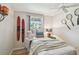 Bright bedroom featuring a ceiling fan, hardwood floors, and fun sports decor at 5055 29Th S St, St Petersburg, FL 33712