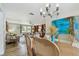 Light-filled dining room open to the living room and featuring a modern chandelier at 5055 29Th S St, St Petersburg, FL 33712