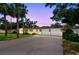 Charming single-story home featuring a spacious driveway, two-car garage, and lush landscaping at 5055 29Th S St, St Petersburg, FL 33712