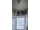 Bathroom with toilet, cabinets, ceiling light and back door at 5105 Bonito Dr, New Port Richey, FL 34652