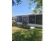 Home exterior featuring a covered, screened-in patio and tidy landscaping at 5105 Bonito Dr, New Port Richey, FL 34652