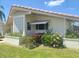 Charming home featuring a patterned concrete accent wall, a small awning, and colorful landscaping at 5105 Bonito Dr, New Port Richey, FL 34652