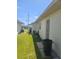 Home exterior showing the side yard with well-maintained lawn and utilities access at 5105 Bonito Dr, New Port Richey, FL 34652