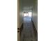 Hallway leading into the main room with sliding glass doors, offering potential for renovation at 5105 Bonito Dr, New Port Richey, FL 34652