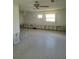 Living room area ready for renovation with exposed studs and terrazzo floors at 5105 Bonito Dr, New Port Richey, FL 34652