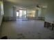 Spacious living room with sliding glass doors and a ceiling fan, ready for customization at 5105 Bonito Dr, New Port Richey, FL 34652