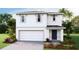 Charming two-story home featuring a white exterior, two car garage and beautifully landscaped front yard at 5236 Salt Marsh Rd, Wimauma, FL 33598