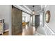 Stylish entryway features sliding barn doors, hardwood floors, and a welcoming atmosphere for guests at 5318 Candler View Dr, Lithia, FL 33547