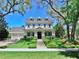 Charming three-story home featuring a manicured lawn, symmetrical design, and classic architectural details at 5318 Candler View Dr, Lithia, FL 33547