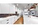 Bright kitchen boasting white cabinets, stainless steel appliances, and stylish backsplash at 5318 Candler View Dr, Lithia, FL 33547
