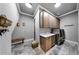 Well-lit laundry room with modern appliances, storage cabinets, and tile floors at 5318 Candler View Dr, Lithia, FL 33547