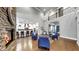 Bright living room showcasing stone fireplace, hardwood floors, open floor plan, and a decorative chandelier at 5318 Candler View Dr, Lithia, FL 33547