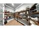 Well-organized pantry with wooden shelves filled with an assortment of food and kitchen items at 5318 Candler View Dr, Lithia, FL 33547