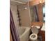 Clean bathroom featuring a shower-tub combo, toilet, vanity, and ample storage space at 5820 N Church Ave # 260, Tampa, FL 33614